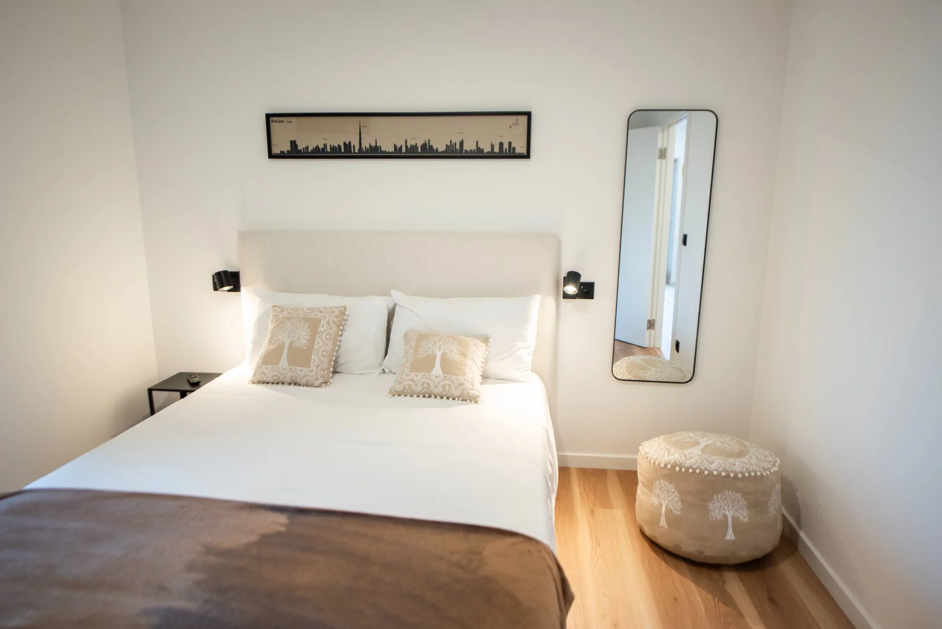 The Dubai room at Latitude, in warm golden tones with the Dubai skyline above the bed