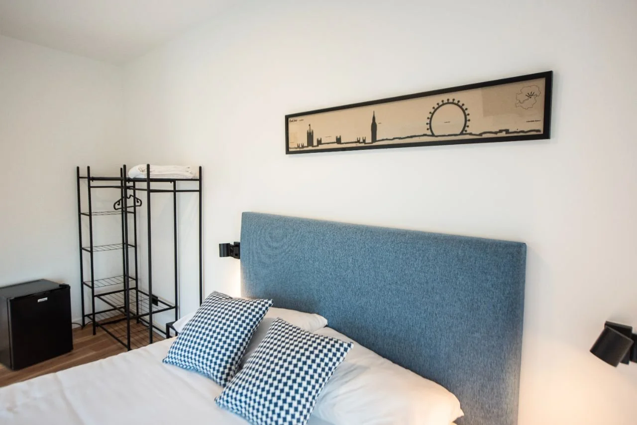 The London room, blue headboard, blue-and-white checked cushions and the London skyline with the London Eye and Big Ben